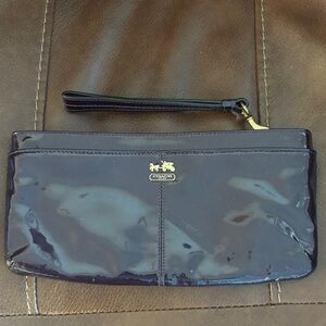 Coach clutch with navy satin interior that has a card holder in there.